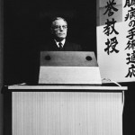 Ancel Keys lecturing at a podium in Japan